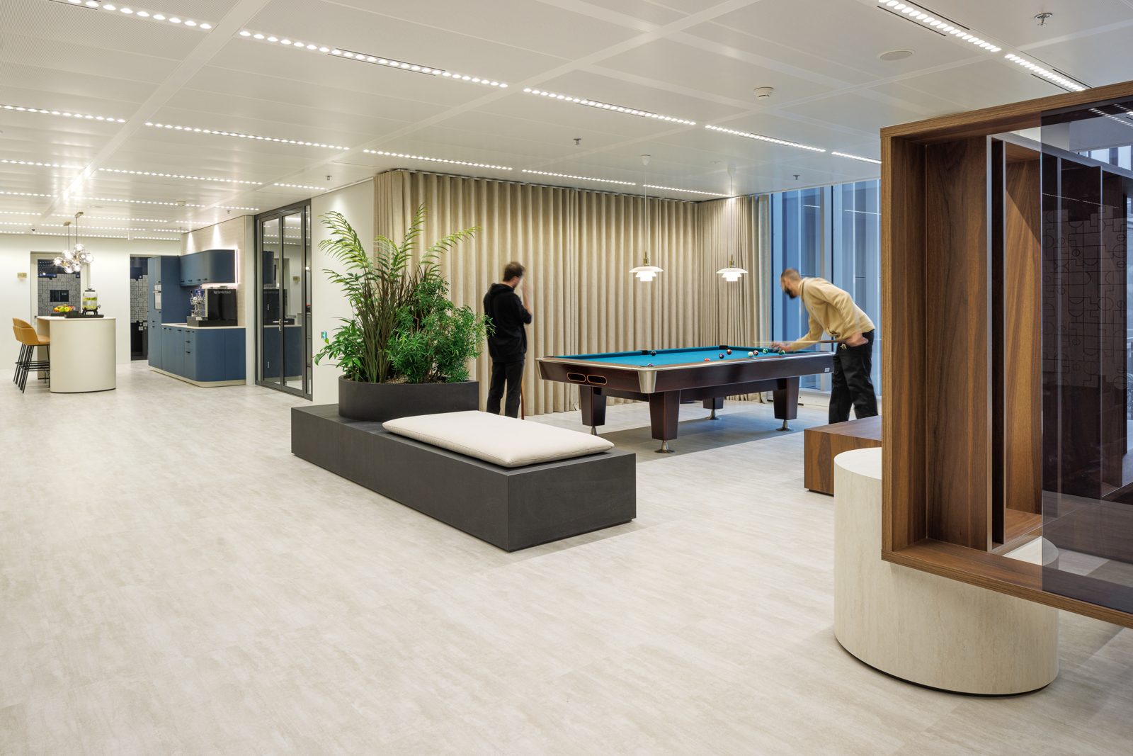 Members playing pool in the Club HOFF game room